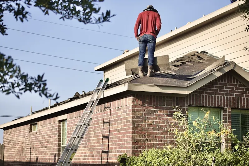 Professional roofer working on a residential roof in Brookside Woods